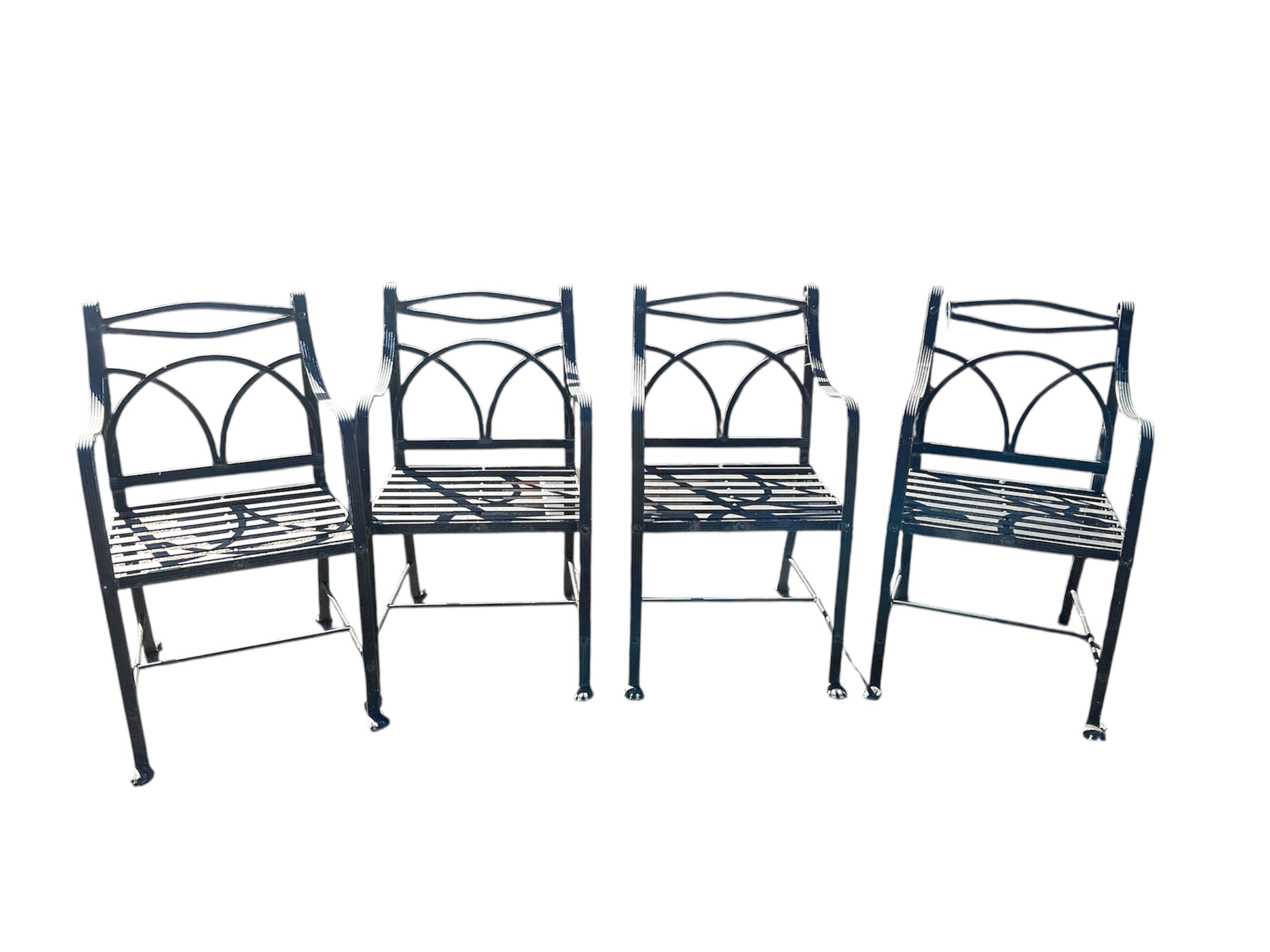 A set of four wrought iron garden chairs, width 53cm, depth 42cm, height 95cm